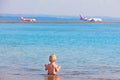 Happy kid watching airplanes landing at beach airport Royalty Free Stock Photo