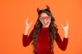 Happy kid wear devil horns and glamour party glasses on halloween, happy halloween party fun