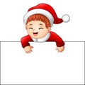 Happy kid wearing santa costume holding blank sign Royalty Free Stock Photo