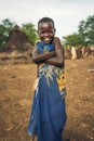 TOPOSA TRIBE, SOUTH SUDAN - MARCH 12, 2020: Happy kid wrapped in colorful cloth smiling for camera and crossing arms while living