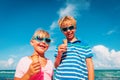 Happy kids- boy and girl- eating ice cream on beach Royalty Free Stock Photo