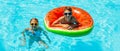 Happy kids, boy and girl in sunglasses, swim and play with inflatable rings in the pool, have fun during family summer vacation Royalty Free Stock Photo