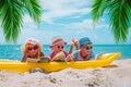 Happy kids- boy and girls read books on beach, family vacation Royalty Free Stock Photo