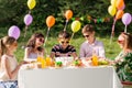 Happy kids with cake on birthday party at summer Royalty Free Stock Photo