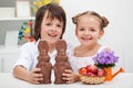 Happy kids with chocolate bunnies Royalty Free Stock Photo