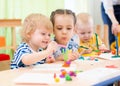 Happy kids doing arts and crafts in day care centre Royalty Free Stock Photo