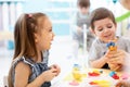 Happy kids doing hand crafts in daycare centre Royalty Free Stock Photo