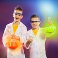 Happy kids doing science experiments in the laboratory. Royalty Free Stock Photo