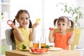 Happy kids eating healthy food in kindergarten or at home Royalty Free Stock Photo