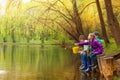 Happy kids fishing together near beautiful pond Royalty Free Stock Photo