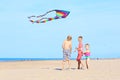 Happy kids flying kite on the beach Royalty Free Stock Photo