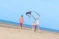 Happy kids flying kite on the beach Royalty Free Stock Photo