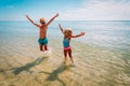 Happy kids- girl and boy- play with waves on beach Royalty Free Stock Photo