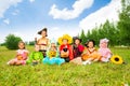 Happy kids in Halloween costumes sit on grass Royalty Free Stock Photo