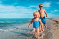 happy kids have fun on beach, boy and girl play at sea Royalty Free Stock Photo