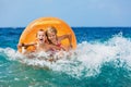 Happy kids have fun in sea surf on beach. Royalty Free Stock Photo