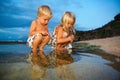 Happy kids have a fun on sunset beach Royalty Free Stock Photo