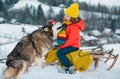 Happy kids having fun with husky dog and riding the sledge in the winter snowy forest, enjoy winter season. Winter Royalty Free Stock Photo