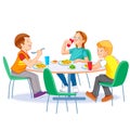 Happy kids having lunch by themselves. Two boys and girl eating lunch meals at table. Child nutrition concept. Royalty Free Stock Photo