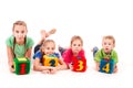 Happy kids holding blocks with numbers over white background Royalty Free Stock Photo