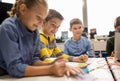 Happy kids with invention kit at robotics school Royalty Free Stock Photo