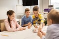 Happy kids with invention kit at robotics school Royalty Free Stock Photo