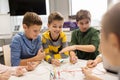 Happy kids with invention kit at robotics school Royalty Free Stock Photo