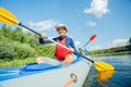 Happy kids kayaking on the river on a sunny day during summer vacation Royalty Free Stock Photo