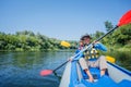 Happy kids kayaking on the river on a sunny day during summer vacation Royalty Free Stock Photo