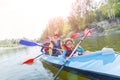 Happy kids kayaking on the river on a sunny day during summer vacation Royalty Free Stock Photo