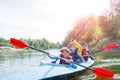 Happy kids kayaking on the river on a sunny day during summer vacation Royalty Free Stock Photo