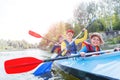 Happy kids kayaking on the river on a sunny day during summer vacation Royalty Free Stock Photo