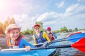 Happy kids kayaking on the river on a sunny day during summer vacation Royalty Free Stock Photo