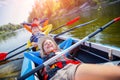 Happy kids kayaking on the river on a sunny day during summer vacation Royalty Free Stock Photo