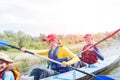 Happy kids kayaking on the river on a sunny day during summer vacation Royalty Free Stock Photo