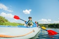 Happy kids kayaking on the river on a sunny day during summer vacation Royalty Free Stock Photo