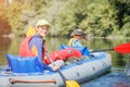 Happy kids kayaking on the river on a sunny day during summer vacation Royalty Free Stock Photo