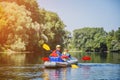 Happy kids kayaking on the river on a sunny day during summer vacation Royalty Free Stock Photo
