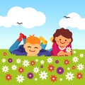 Happy kids laying on meadow field grass