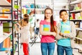 Happy kids in library stand together with books