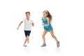 Happy little caucasian girl and boy jumping and running isolated on white background Royalty Free Stock Photo