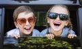 Happy kids looking out the car window