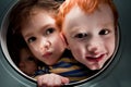 Happy kids looking through window porthole