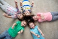 Happy kids lying on floor and showing thumbs up Royalty Free Stock Photo