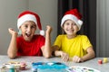 Happy kids making christmas cards wearing santa hats Royalty Free Stock Photo