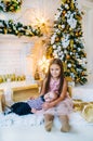 Happy kids near a Christmas tree. Holiday atmosphere Royalty Free Stock Photo