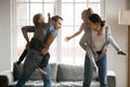 Happy kids piggyback parents playing at home together Royalty Free Stock Photo