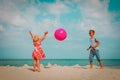 Kids play with ball on beach, boy and girl have fun at sea Royalty Free Stock Photo