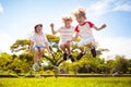 Happy kids play outdoor. Children skipping rope Royalty Free Stock Photo