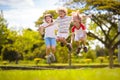 Happy kids play outdoor. Children skipping rope